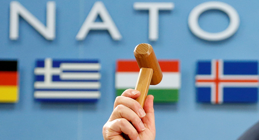 NATO Secretary-General Jens Stoltenberg holds up a ceremonial hammer at the start of a NATO-Georgia defence ministers meeting at the Alliance headquarters in Brussels, Belgium February 16, 2017.